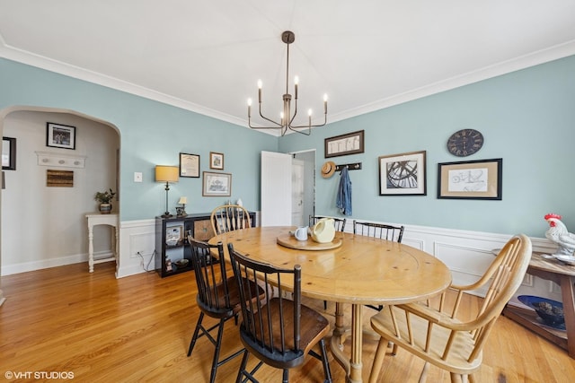 307 W Harris Ave Unit 3A, La Grange, IL 60525 - dining space featuring arched walkways, light wood-type flooring, ornamental molding, a chandelier, and wainscoting