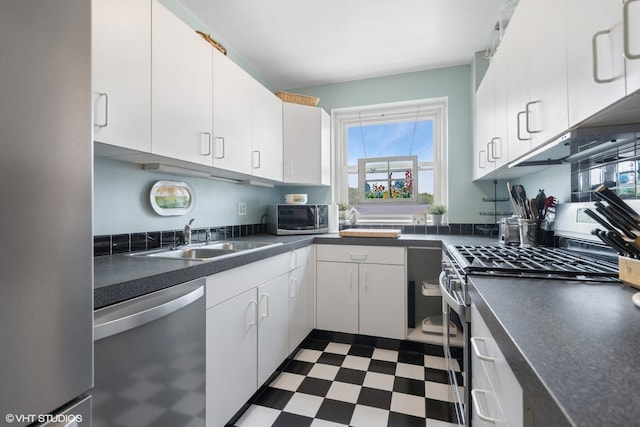 307 W Harris Ave Unit 3A, La Grange, IL 60525 - kitchen featuring appliances with stainless steel finishes, dark flooring, a sink, dark countertops, and white cabinets