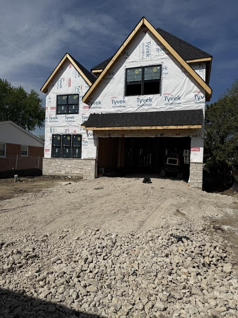 740 S Berkley Ave, Elmhurst, IL 60126 - property under construction with stone siding, driveway, and an attached garage