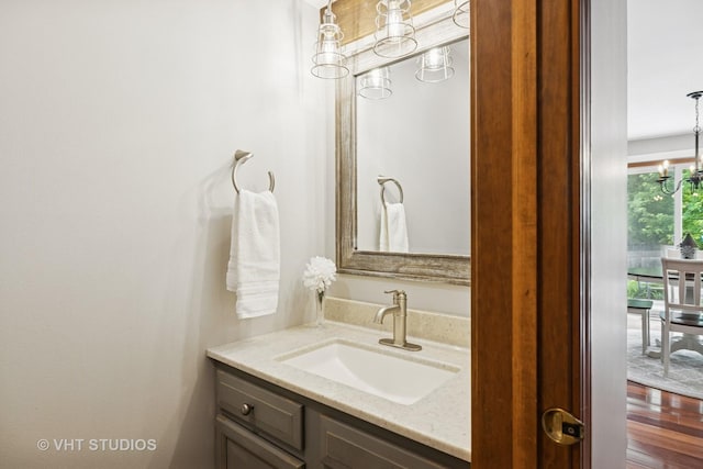 1006 Tristram Ct, West Dundee, IL 60118 - bathroom with a chandelier, vanity, and wood finished floors