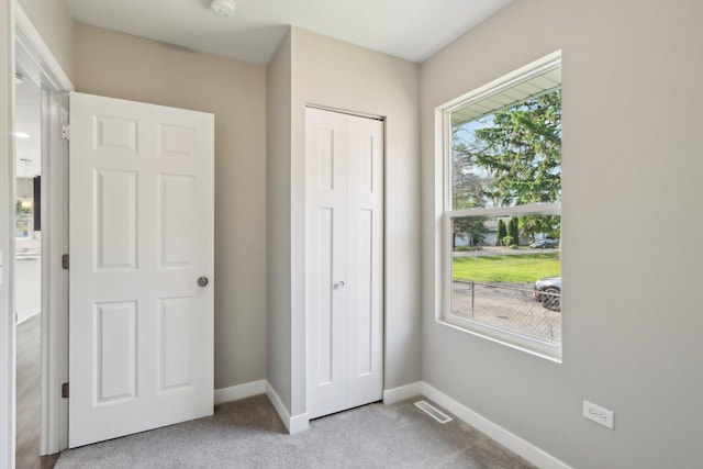 1508 N Lake Shore Dr, Round Lake Beach, IL 60073 - unfurnished bedroom featuring carpet flooring, baseboards, and a closet