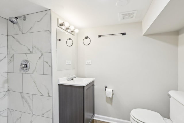 1508 N Lake Shore Dr, Round Lake Beach, IL 60073 - bathroom featuring toilet, vanity, and tiled shower