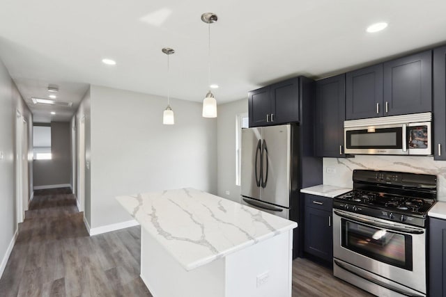 1508 N Lake Shore Dr, Round Lake Beach, IL 60073 - kitchen featuring appliances with stainless steel finishes, wood finished floors, a center island, light stone countertops, and decorative backsplash