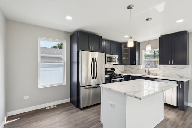 1508 N Lake Shore Dr, Round Lake Beach, IL 60073 - kitchen with stainless steel appliances, a sink, tasteful backsplash, glass insert cabinets, and a center island