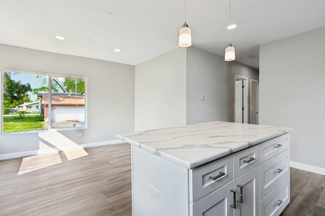 1508 N Lake Shore Dr, Round Lake Beach, IL 60073 - kitchen with baseboards, light wood finished floors, pendant lighting, a kitchen island, and recessed lighting