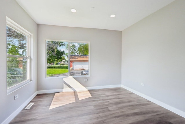 1508 N Lake Shore Dr, Round Lake Beach, IL 60073 - empty room with plenty of natural light, recessed lighting, wood finished floors, and baseboards