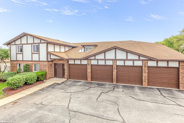 5008 W 122nd St Unit 2B, Alsip, IL 60803 - tudor house with asphalt driveway, brick siding, and a shingled roof