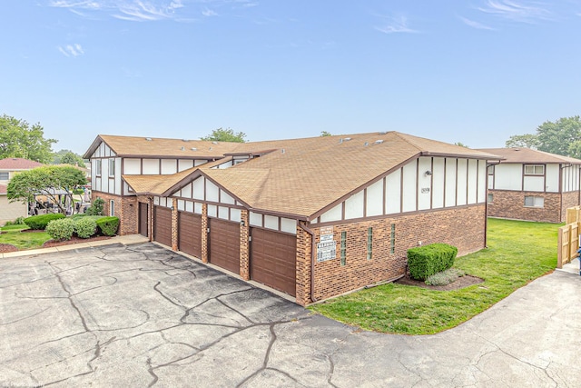 5008 W 122nd St Unit 2B, Alsip, IL 60803 - rear view of property with board and batten siding, an attached garage, driveway, and brick siding