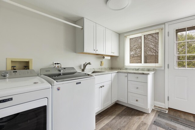 1452 Hemlock Knoll Ter, Northbrook, IL 60062 - laundry room with washing machine and dryer, light wood-style floors, and cabinet space