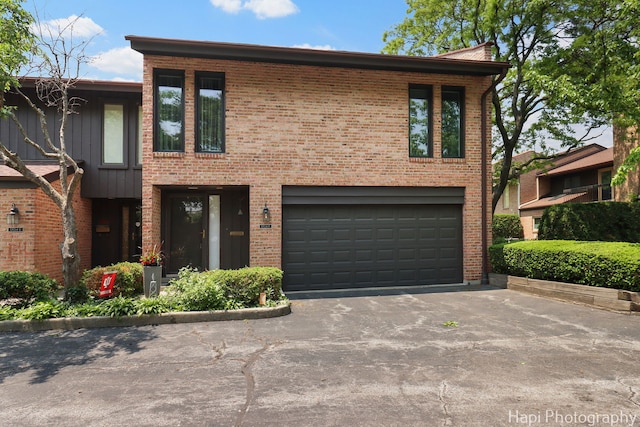 1704 Wildberry Dr Unit F, Glenview, IL 60025 - view of front of house with an attached garage, asphalt driveway, and brick siding