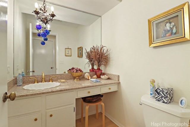 1704 Wildberry Dr Unit F, Glenview, IL 60025 - half bathroom with toilet, vanity, and a chandelier