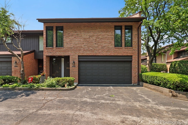 1704 Wildberry Dr Unit F, Glenview, IL 60025 - view of front of property with asphalt driveway, brick siding, and an attached garage