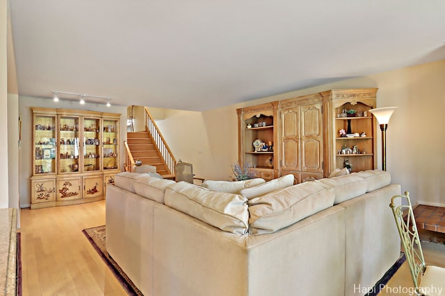 1704 Wildberry Dr Unit F, Glenview, IL 60025 - living room featuring stairway, light wood-style flooring, and rail lighting