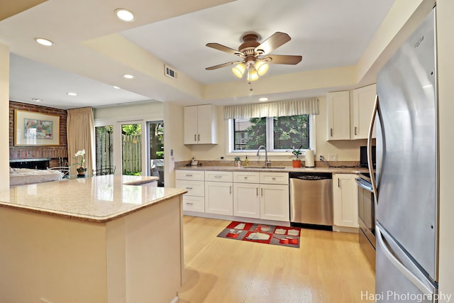 1704 Wildberry Dr Unit F, Glenview, IL 60025 - kitchen with appliances with stainless steel finishes, a sink, white cabinets, light wood finished floors, and recessed lighting