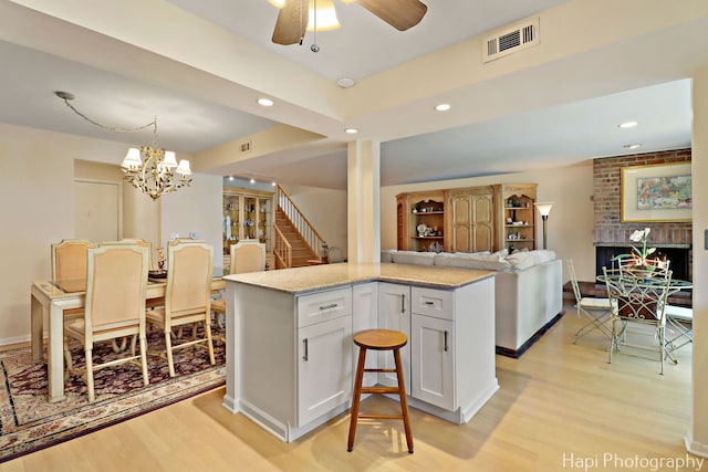 1704 Wildberry Dr Unit F, Glenview, IL 60025 - kitchen with light wood-style flooring, open floor plan, white cabinetry, light stone countertops, and recessed lighting