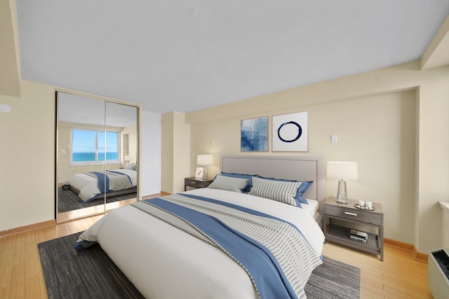 1440 N Lake Shore Dr Unit 10C, Chicago, IL 60610 - bedroom featuring light wood-style flooring, a closet, and baseboards