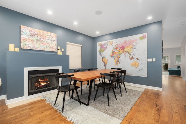 1828 N California Ave, Chicago, IL 60647 - dining area featuring wood finished floors, a lit fireplace, and recessed lighting