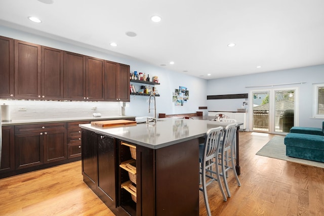 1828 N California Ave, Chicago, IL 60647 - kitchen featuring open shelves, open floor plan, a breakfast bar, recessed lighting, and light wood finished floors