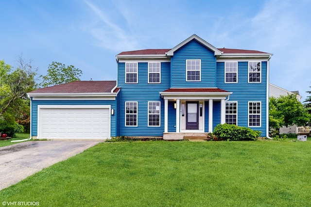 154 Wildflower Ln, Round Lake Beach, IL 60073 - colonial house with asphalt driveway, a front lawn, and an attached garage