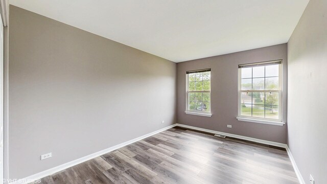 154 Wildflower Ln, Round Lake Beach, IL 60073 - spare room with wood finished floors and baseboards