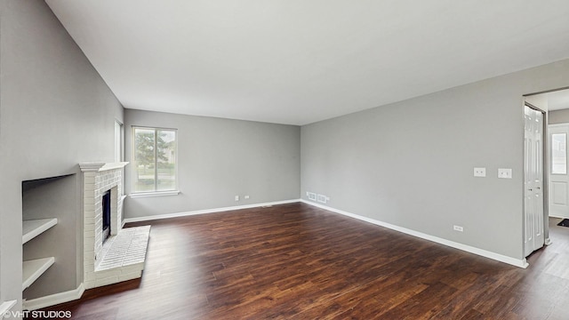 154 Wildflower Ln, Round Lake Beach, IL 60073 - unfurnished living room with dark wood-style floors, a fireplace, and baseboards