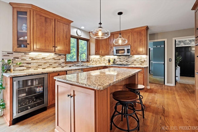 39W841 Prunetree Ln, Saint Charles, IL 60175 - kitchen with stainless steel appliances, beverage cooler, a kitchen island, light wood-type flooring, and recessed lighting