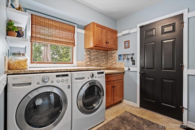 39W841 Prunetree Ln, Saint Charles, IL 60175 - laundry room with washing machine and dryer, cabinet space, light tile patterned flooring, and baseboards