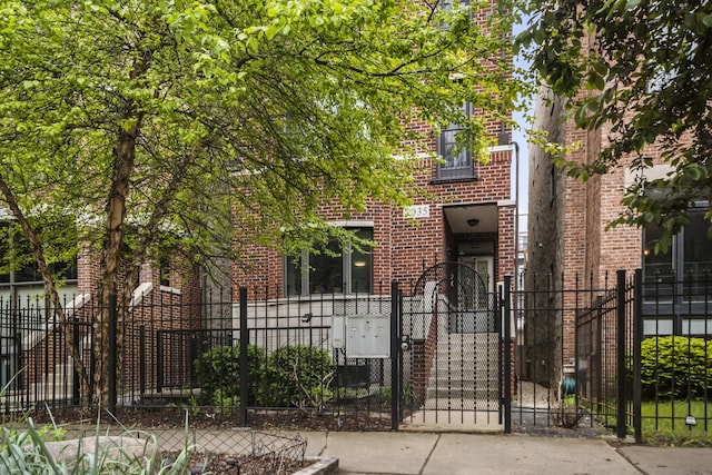 2035 W Crystal St Unit 3, Chicago, IL 60622 - view of front of house with a fenced front yard, brick siding, and a gate