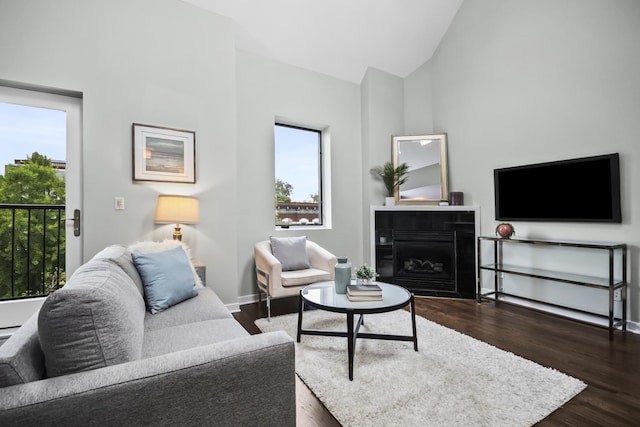 2035 W Crystal St Unit 3, Chicago, IL 60622 - living room with plenty of natural light, dark wood-type flooring, a tile fireplace, high vaulted ceiling, and baseboards