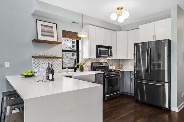 2035 W Crystal St Unit 3, Chicago, IL 60622 - kitchen featuring stainless steel appliances, a peninsula, decorative backsplash, white cabinets, and dark wood finished floors