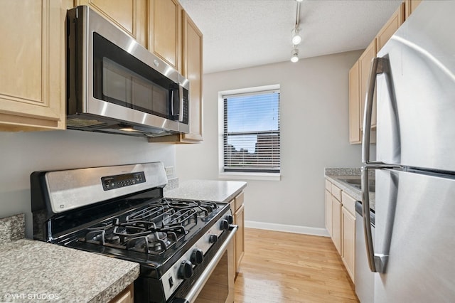 1529 S State St Unit 11B, Chicago, IL 60605 - kitchen with appliances with stainless steel finishes, light wood finished floors, light countertops, light brown cabinetry, and a textured ceiling