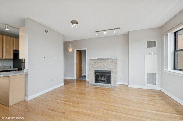 1529 S State St Unit 11B, Chicago, IL 60605 - unfurnished living room featuring track lighting, light wood-style floors, a fireplace, and a heating unit