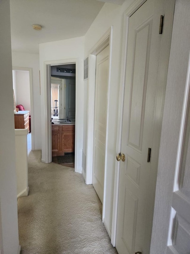 152 W Chatham Ln, Round Lake, IL 60073 - hallway featuring light carpet, baseboards, and a sink