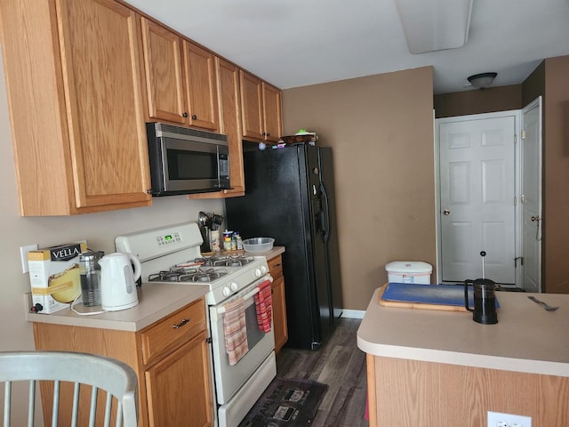 152 W Chatham Ln, Round Lake, IL 60073 - kitchen featuring gas range gas stove, dark wood finished floors, light countertops, and black refrigerator with ice dispenser