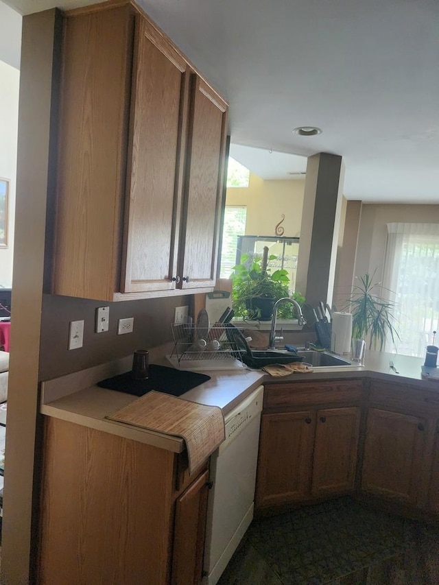 152 W Chatham Ln, Round Lake, IL 60073 - kitchen featuring white dishwasher, a sink, plenty of natural light, recessed lighting, and brown cabinetry
