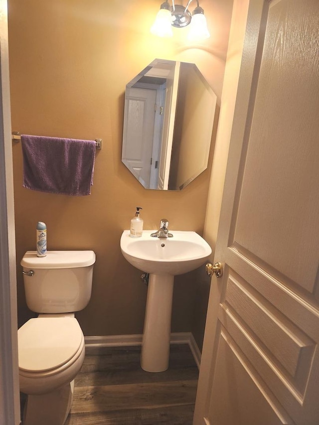 152 W Chatham Ln, Round Lake, IL 60073 - half bathroom with baseboards, wood finished floors, toilet, and a sink