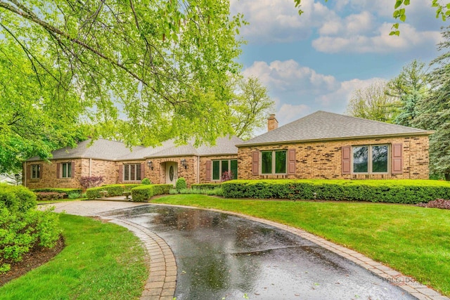 15 Highview Cir, Hawthorn Woods, IL 60047 - view of front of property featuring a chimney, brick siding, curved driveway, and a front yard