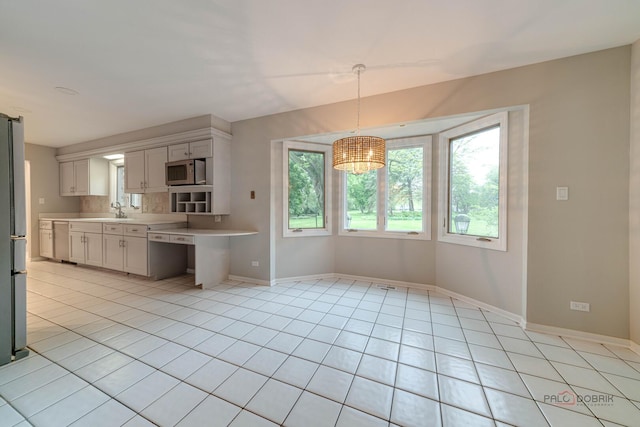 15 Highview Cir, Hawthorn Woods, IL 60047 - kitchen featuring a sink, light countertops, light tile patterned floors, appliances with stainless steel finishes, and baseboards
