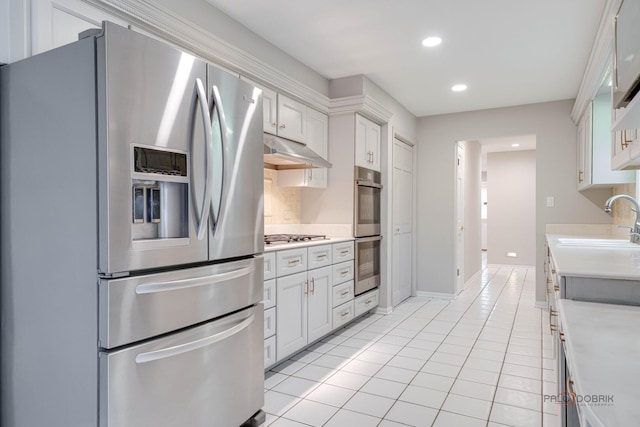 15 Highview Cir, Hawthorn Woods, IL 60047 - kitchen with stainless steel appliances, a sink, light countertops, under cabinet range hood, and light tile patterned floors
