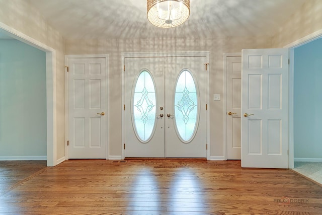 15 Highview Cir, Hawthorn Woods, IL 60047 - foyer entrance with hardwood / wood-style flooring, baseboards, a chandelier, and french doors