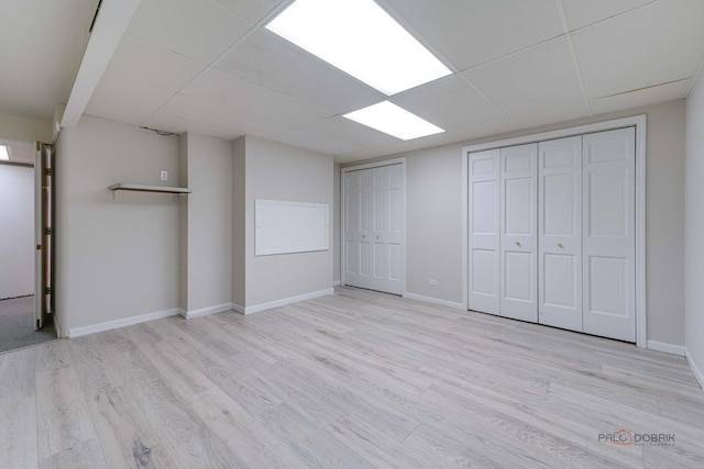 15 Highview Cir, Hawthorn Woods, IL 60047 - unfurnished bedroom with wood finished floors, baseboards, multiple closets, and a paneled ceiling