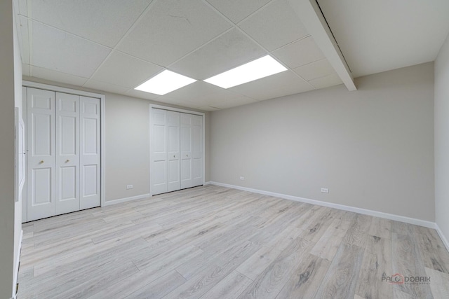 15 Highview Cir, Hawthorn Woods, IL 60047 - unfurnished bedroom with multiple closets, light wood-style floors, and baseboards