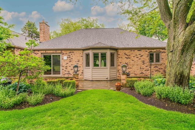 15 Highview Cir, Hawthorn Woods, IL 60047 - view of front facade featuring brick siding, a front yard, a chimney, a shingled roof, and a patio area