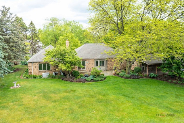 15 Highview Cir, Hawthorn Woods, IL 60047 - view of front of house with a front lawn, a chimney, and brick siding