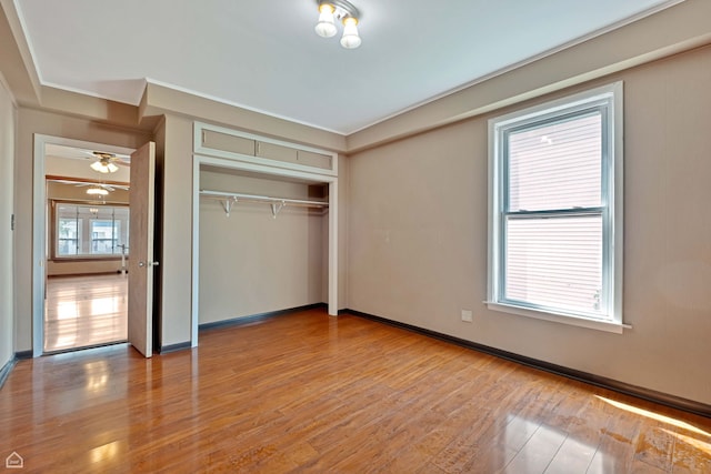 4042 N Kenneth Ave, Chicago, IL 60641 - unfurnished bedroom with light wood-type flooring, crown molding, and a closet