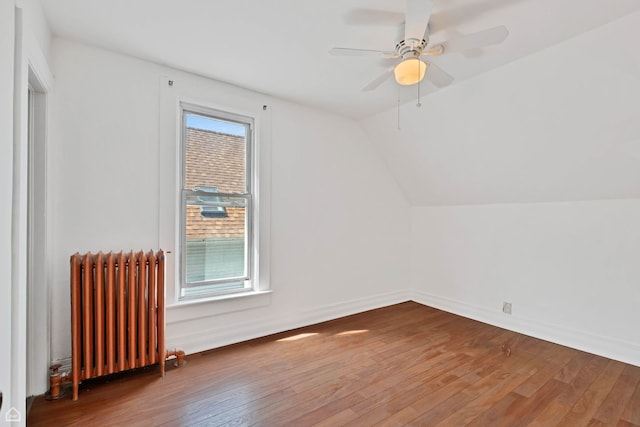 4042 N Kenneth Ave, Chicago, IL 60641 - additional living space with radiator heating unit, wood finished floors, ceiling fan, and vaulted ceiling