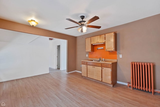 4042 N Kenneth Ave, Chicago, IL 60641 - kitchen featuring radiator heating unit, a ceiling fan, light countertops, light wood-type flooring, and light brown cabinetry