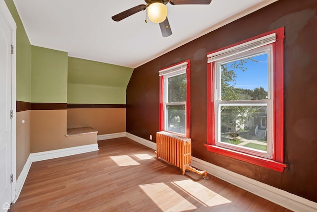 4042 N Kenneth Ave, Chicago, IL 60641 - bonus room featuring radiator heating unit, wood finished floors, a ceiling fan, and lofted ceiling