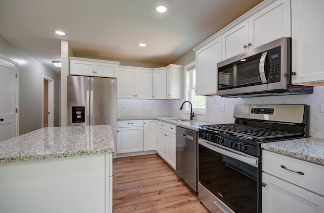 382 W 3rd St, Braidwood, IL 60408 - kitchen with stainless steel appliances, white cabinets, light wood-style flooring, decorative backsplash, and recessed lighting