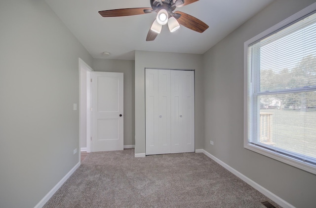 382 W 3rd St, Braidwood, IL 60408 - unfurnished bedroom with multiple windows, carpet flooring, a closet, and ceiling fan